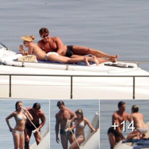 Scarlett Johansson's bodyguard keeps her under very close surveillance... as she sunbathes in a white bikini