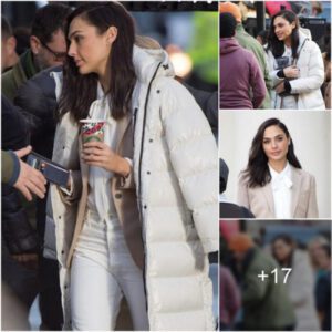 Gal Gadot shrouds herself in a padded coat and hugs a hot water bottle as attempts to keep warm while filming an advert in London