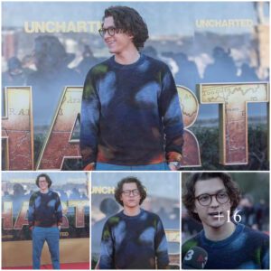 Tom Holland opts for geek chic in his glasses and a tie dye sweater as he attends Barcelona photocall for video game film Uncharted