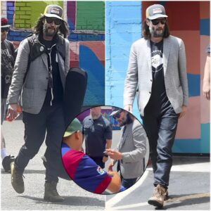 Keanu Reeves signs autographs for fans while carrying his bass guitar