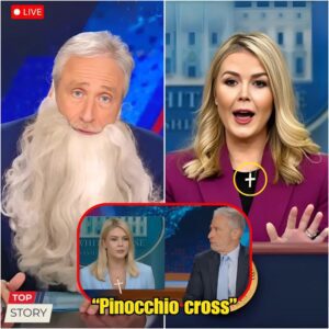 KAROLINE LEAVITT HUMILIATED BY JON STEWART — AND JUST DAYS LATER, SHE TOOK OFF HER CROSS NECKLACE. She finally ditched her signature necklace this week—right after Stewart torched her live on The Daily Show.