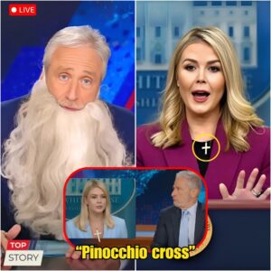 KAROLINE LEAVITT HUMILIATED BY JON STEWART — AND JUST DAYS LATER, SHE TOOK OFF HER CROSS NECKLACE. She finally ditched her signature necklace this week—right after Stewart torched her live on The Daily Show. van