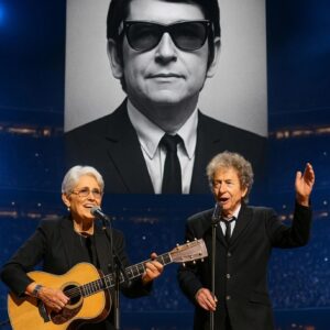 Joan Baez walked onto the stage, guitar in hand, and 70,000 fans fell into a hush. “This song is for my friend, Roy Orbison,” she said softly, as his image lit up the massive LED screen behind her. ws