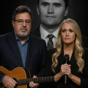 Vince Gill and Carrie Underwood walked side by side to center stage. Vince clutched his guitar to his chest, while Carrie held the microphone with trembling hands.
