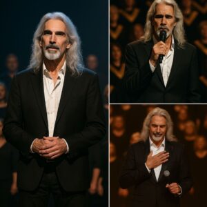 The lights dimmed, but not all the way — just enough to let the hush settle in. Guy Penrod stepped forward, slower than usual, the silver in his hair catching the glow like threads of heaven. ws